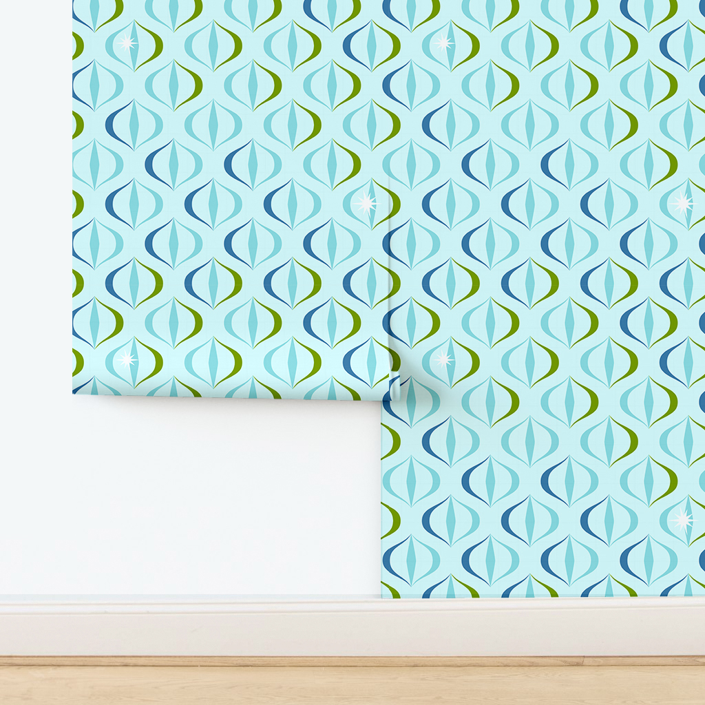 The artwork features a repeating geometric pattern of symmetrical shapes resembling elongated, curved diamonds or petals in various shades of blue and green. Each shape is split vertically with one half filled with a light blue and the other half filled with green or darker blue. The background is a light, almost pastel blue, which provides a soft yet vibrant backdrop. One of the blue shapes near the upper left contains a white starburst element, adding a focal point of brightness to the composition. The overall design conveys a modern, mid-century aesthetic with clean lines and harmonious color contrasts.